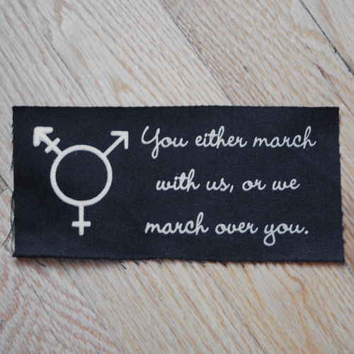 Sales of the "March with us" patch support Trans Lifeline.