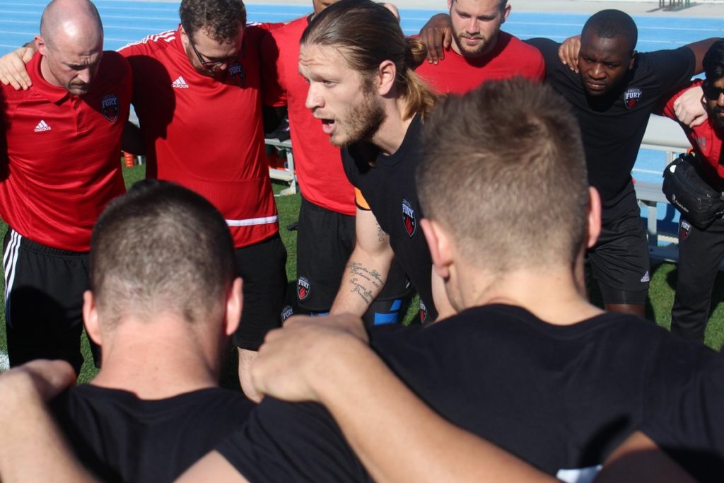 Players huddle around new club captain Lance Rozeboom. Photo courtesy Ottawa Fury FC.