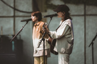 Tegan and Sara singing on stage together